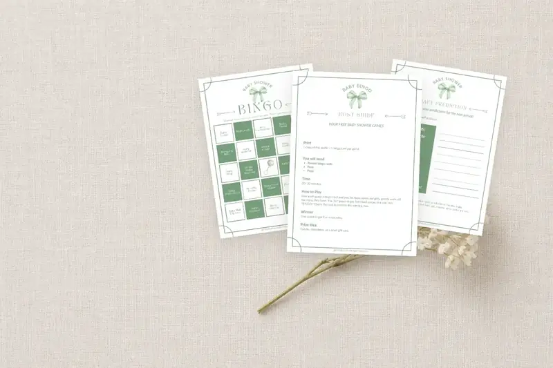 Printed baby shower game cards laid out on linen