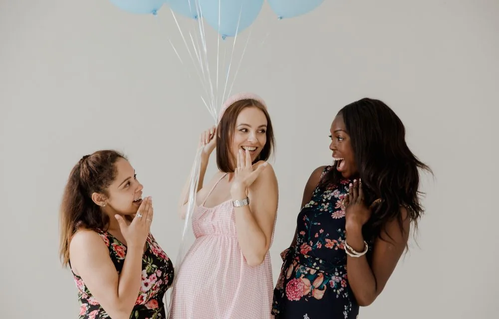 Women celebrating at a baby shower with balloons