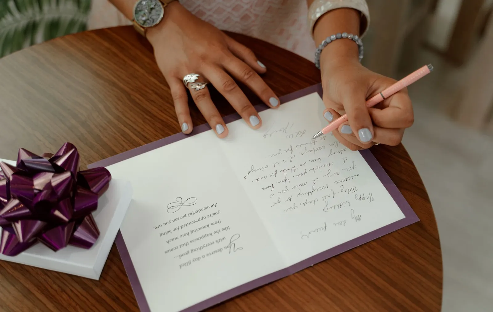 Guests writing advice cards at a craft table during a baby shower