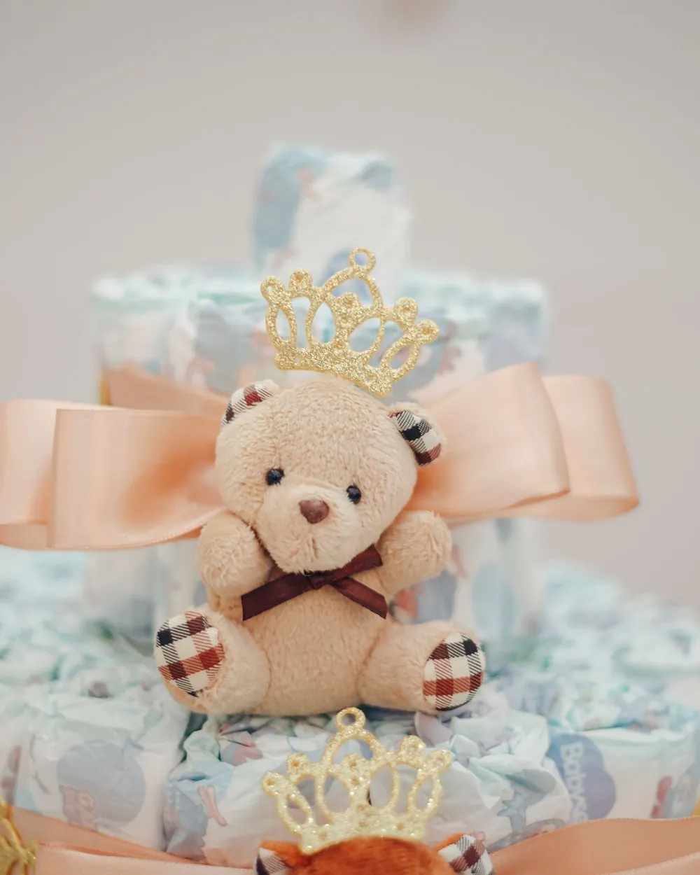 Diaper cake with a teddy bear on a baby shower table