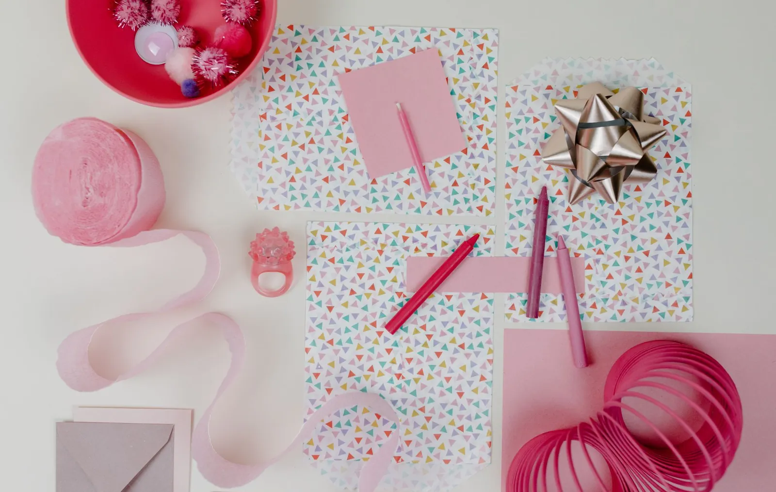 Guests playing free printable baby shower games at a table with pencils and game cards