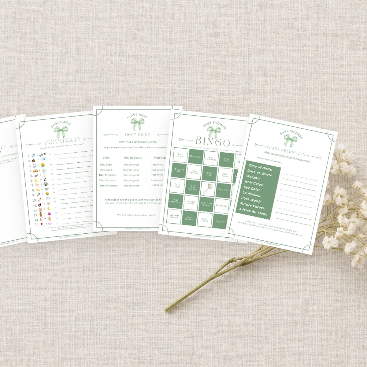 Printed baby shower game cards laid out on linen